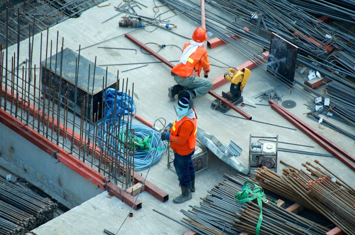 Construction workers fixing steel reinforcement on site